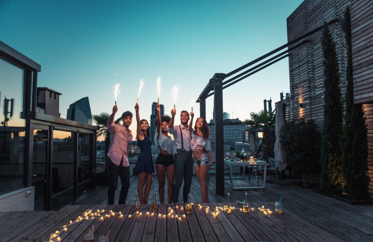Multi-ethnic group of friends having party on rooftop - Happy people bonding and having fun