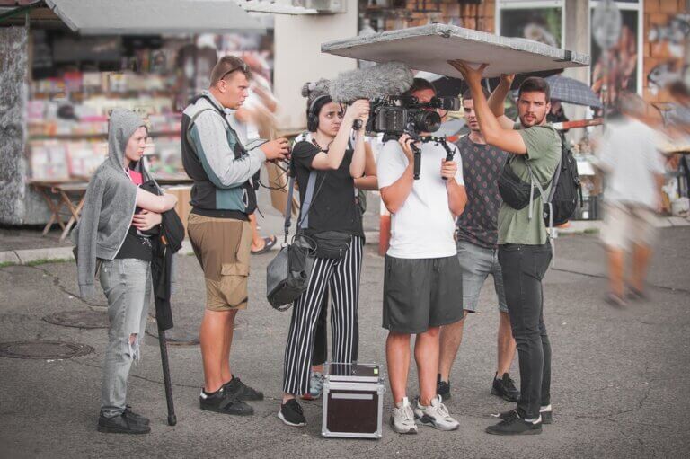 A production assistant and the rest of the production crew working on another film.