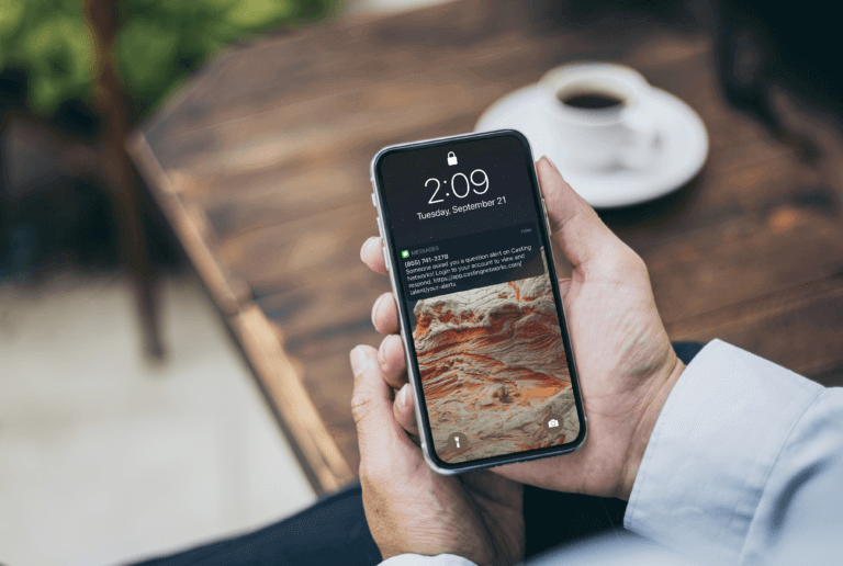 Mockup image of woman's hand holding using white mobile phone at outdoor with copy space,blank screen for text.concept for business,people communication,technology electronic device. modern life