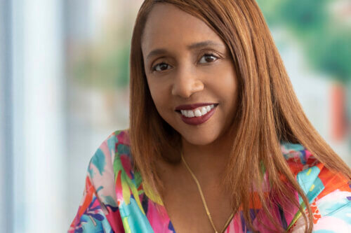 Talent agent Sharron Banks in a rainbow shirt smiling.