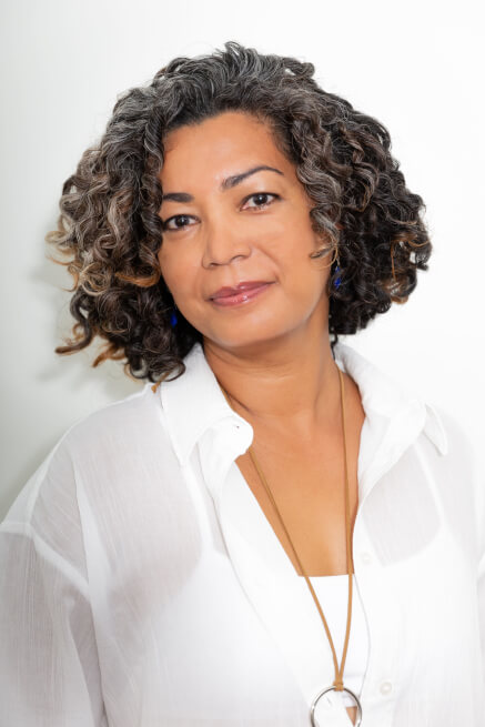 Actor Daniella Barsotti smiling in a white shirt.