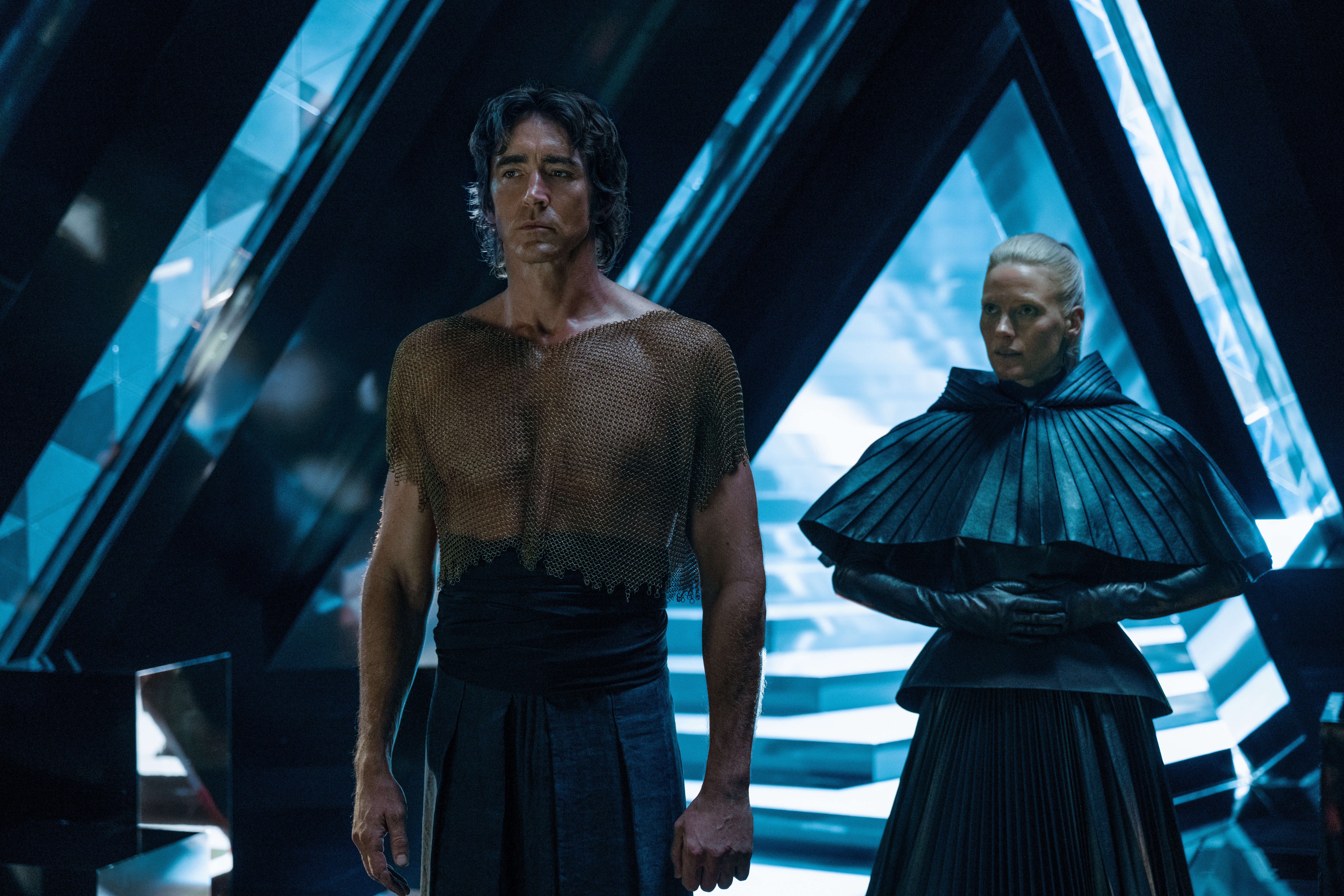Lee Pace and Laura Birn standing in a sci-fi hallway.