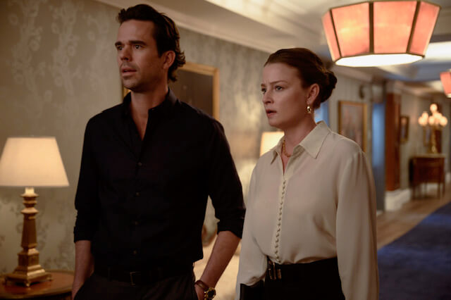 Rachel Nichols standing next to a man inside a hotel hall.
