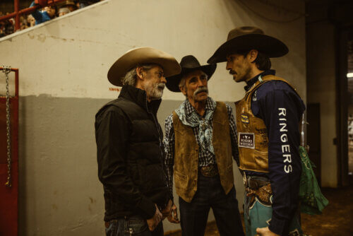 Three roedo cowboys strategizing by a wall.