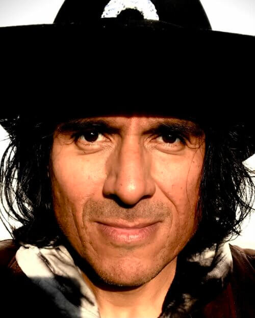 Ernesto García-Orduña in Western gear smiling.