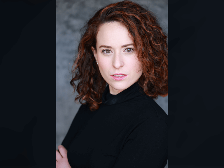 Audrey Del Prete in a black sweater looking serious.