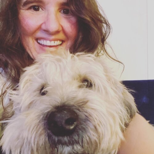 Mia Cusumano smiling with her dog.