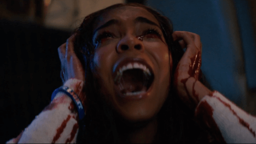 Woman screaming covered in blood.