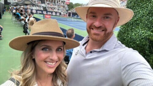 Chase Paris and his wife at a tennis event wearing matching hats.