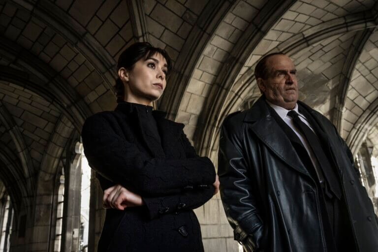 Colin Ferrell as "The Penguin" standing with Cristin Milioti in a church.