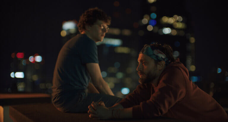 Jesse Eisenberg and Kieran Culkin hanging out at night in Poland.