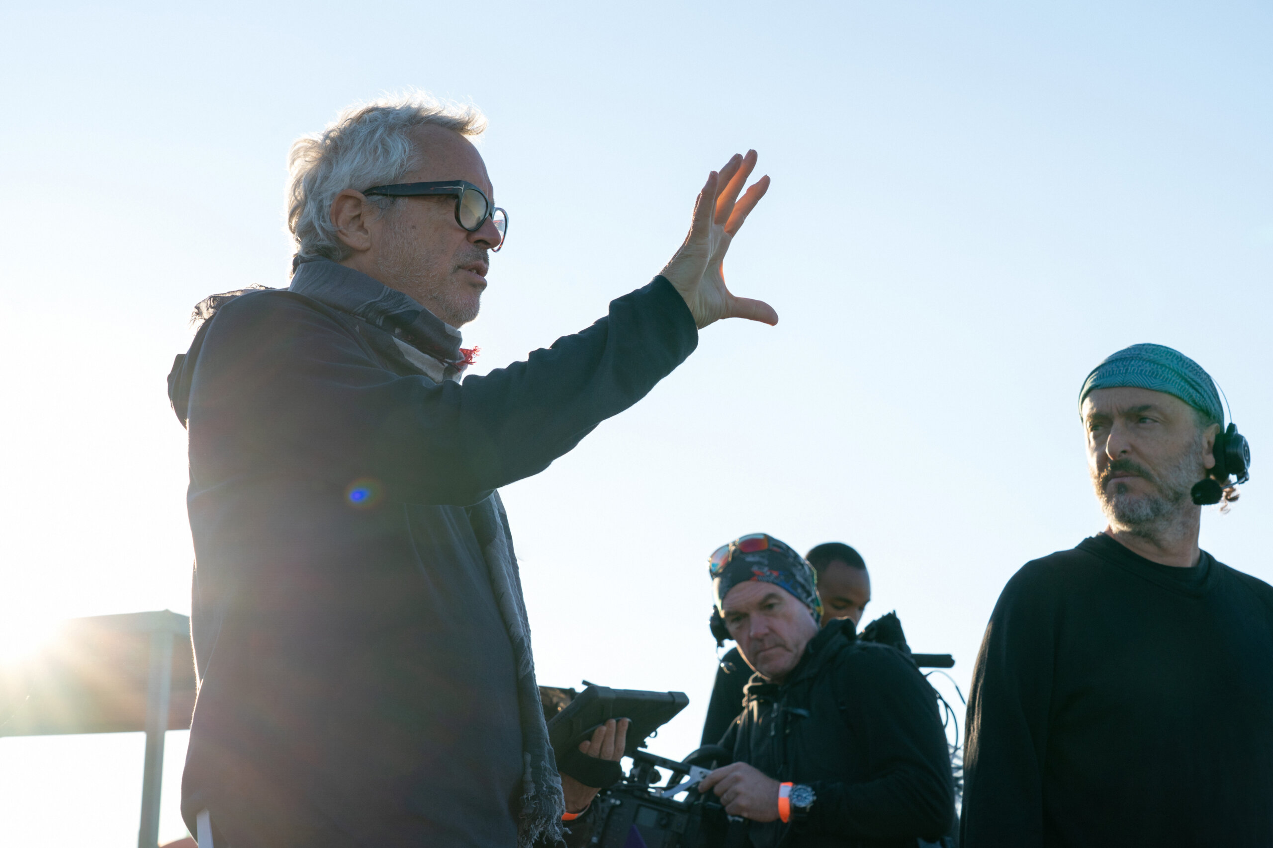 Writer, executive producer and director Alfonso Cuarón with executive producer and cinematographer Emmanuel “Chivo” Lubezk talking outside while working on Apple TV+'s Disclaimer.
