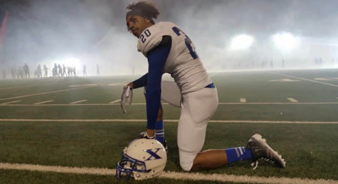 Matthew Horn on a football field in full football uniform and Adidas socks.