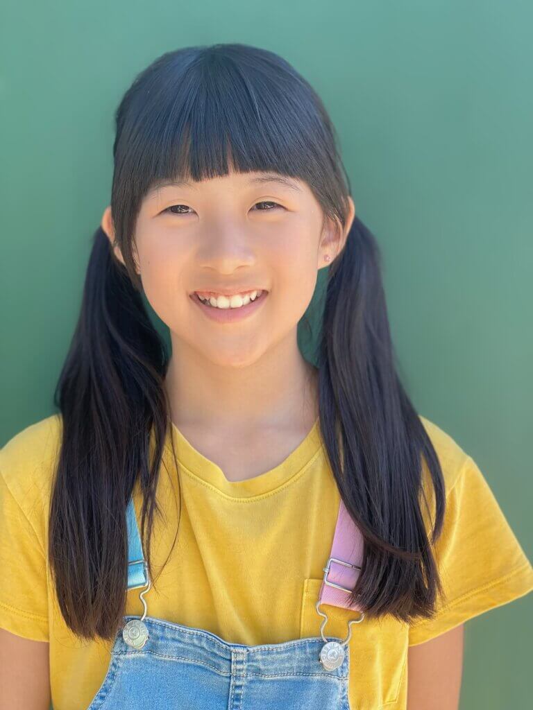 Casting Networks Discover Youth Talent Winner Claudia Peng smiling in a yellow shirt.