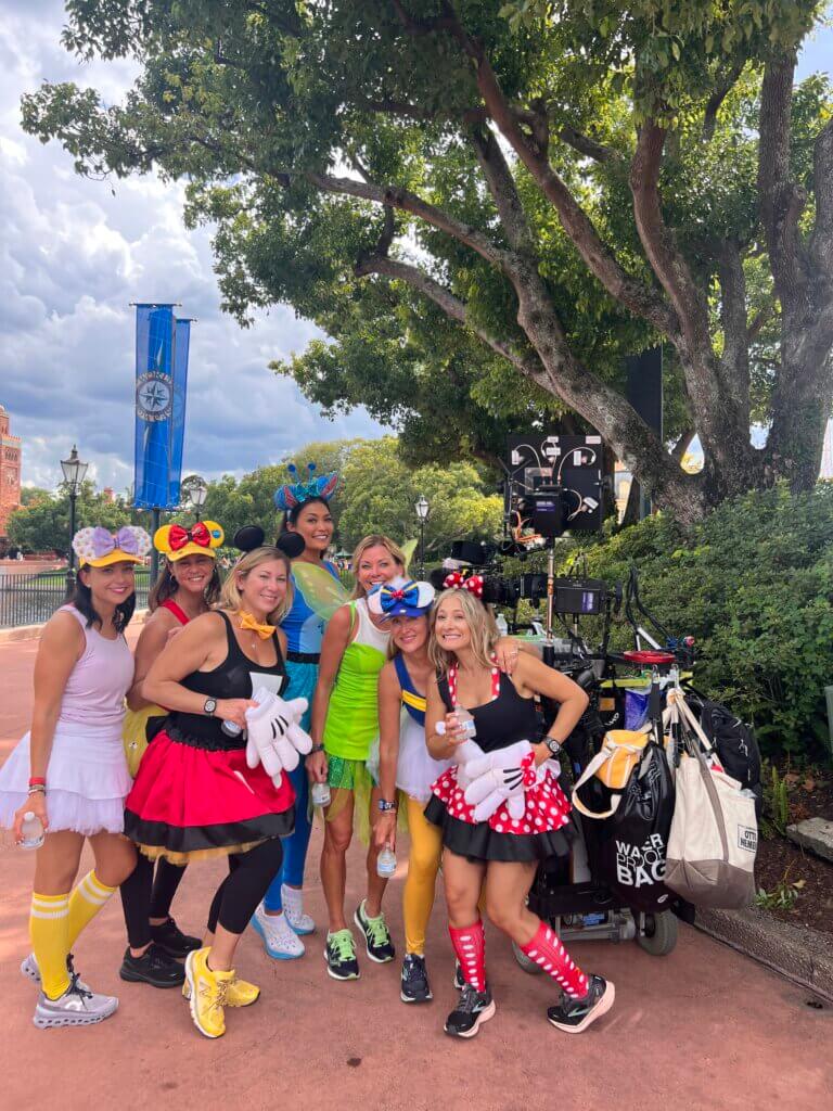 Actor Amy Mckillop and friends posing in front of a camera at Disney World