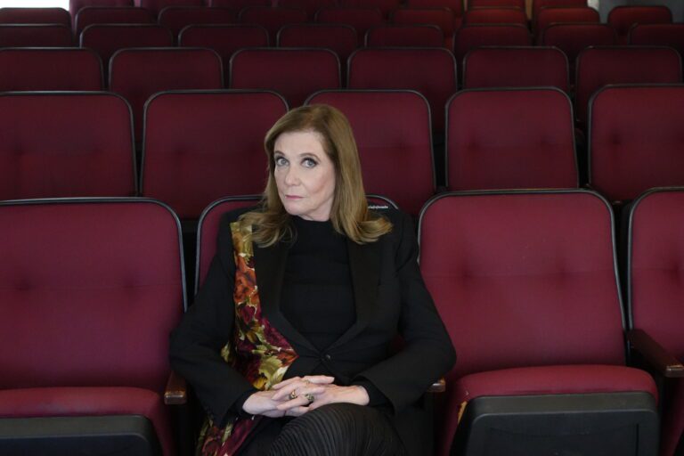 Acting teacher Ivana Chubbuck sitting in the front row of a theater in a black shirt.
